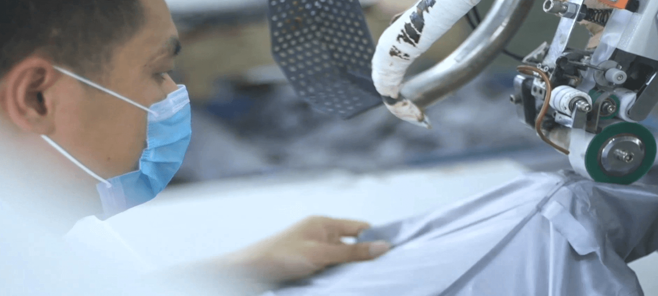 Factory operator carrying out precision garment work
